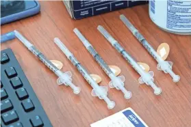  ?? DOUG HOKE/THE OKLAHOMAN ?? COVID-19 vaccines ready for use are shown on a desk at the Mercy vaccine clinic.