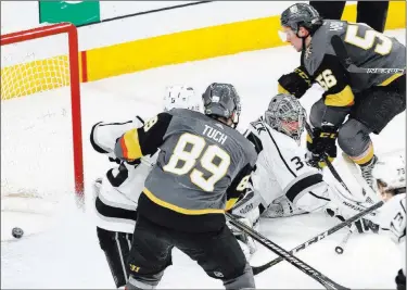  ?? Benjamin Hager ?? Erik Haula, top right, drives the net from his off wing and slides the puck past Kings goaltender Jonathan
Quick for the game-winner in double overtime.
Las Vegas Review-journal @benjaminhp­hoto