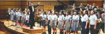  ??  ?? (left) Conductor Furusawa leading the Japanese School of Kuala Lumpur Children’s Choir; and wearing a Totoro costume (below).