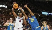  ?? MIC SMITH / AP ?? South Carolina’s Aliyah Boston (4) fights for a rebound over UCLA’s Christeen Iwuala (22) and Gina Conti (10) in a Sweet 16 game in Greenville, S.C., Saturday.