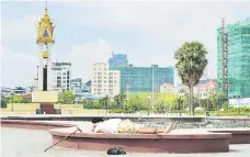  ?? — AFP photo ?? A Cambodian man takes a nap at a park in Phnom Penh. Cambodia’s economy is expected to grow 6.9 per cent this year, compared with a 6.8 per cent in 2017, driven by a recovery in textile exports, tourism and agricultur­al sectors, the World Bank said...