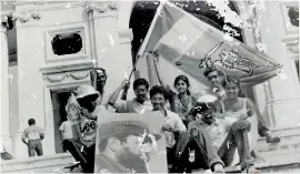  ??  ?? The Sri Lankan flag is held high by Ananda along with a huge photo of Castro in Havana on May Day 1986, while Nuwan in a white cap is seated in a photograph snapped in front of the Revolution­ary Palace in Cuba