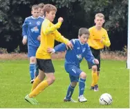  ??  ?? Action from Kirriemuir (blue) against Pitfour in the U/13 section at Graham Street.