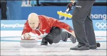  ?? AP PHOTO ?? Canada’s skip Kevin Koe throws a rock during a men’s curling match against Italy on Wednesday.