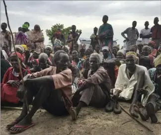  ?? SAM MEDNICK, THE ASSOCIATED PRESS ?? Displaced South Sudanese gather during a visit of UN Refugee Agency High Commission­er Filippo Grandi to a new site for displaced people outside of the UN protected camp, in Bentiu, South Sudan, Sunday.