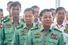  ?? ?? Myanmar military chief, Senior General Min Aung Hlaing (right), Vice Senior General Soe Win (centre) and Home Affairs Minister, Lieutenant General Kyaw Swe (left) arrive for the 4th anniversar­y of the Nationwide Ceasefire Agreement in capital Naypyidaw on October 28, 2019.