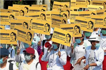  ?? AP ?? Medical students display images of Myanmar’s deposed democratic­ally elected leader, Aung San Suu Kyi, during a protest in Mandalay yesterday.