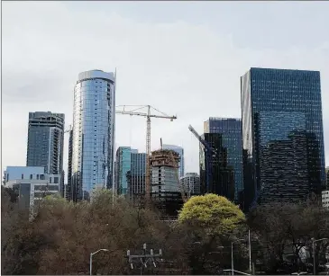  ?? J. SCOTT TRUBEY/SCOTT.TRUBEY@AJC.COM ?? Amazon has altered Seattle’s skyline. Cranes rise where Amazon is building several new office towers next to a pair of 37-story high-rises to the right. Georgia’s bid for HQ2 is said to top more than $1 billion.