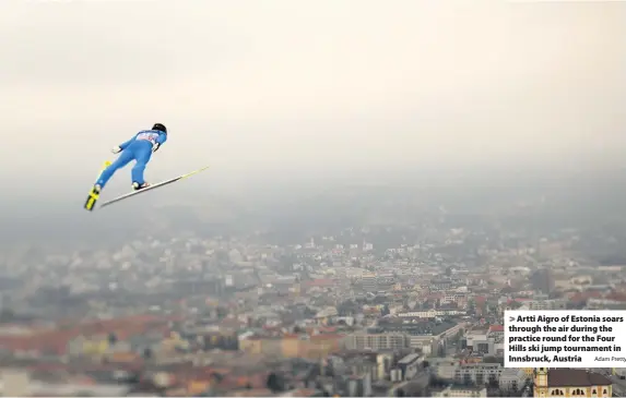  ?? Adam Pretty ?? Artti Aigro of Estonia soars through the air during the practice round for the Four Hills ski jump tournament in Innsbruck, Austria