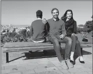  ?? AP/JEFF CHIU ?? Mike Gougherty (center) and Julie Rajagopal pose for photos with their 16-year-old foster child from Eritrea at Dolores Park in San Francisco. When their foster child landed in March, he was among the last refugee foster children to make it into the U.S.