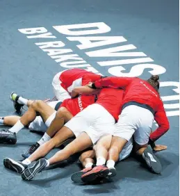  ?? Photo / AP ?? Canada celebrate after clinching the Davis Cup in Malaga.