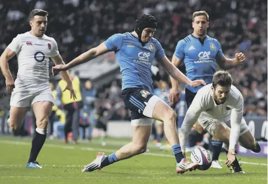  ??  ?? 2 Italian Carlo Canna denies England’s Elliot Daly a secondhalf try as he races in to boot the ball into touch.