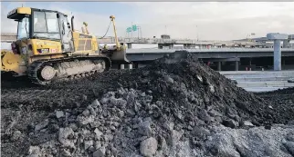  ?? ALLEN McINNIS ?? A bulldozer operator builds up an embankment along the Ville-Marie Expressway near the Decarie Expressway north ramp as part of the Turcot Interchang­e project.