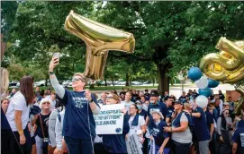  ?? ?? Penn State Vice President of Intercolle­giate Athletics Sandy Barbour takes a selfie with the crowd before the “Roar and Rally” walk to celebrate the 50th Anniversar­y of Title IX on Thursday, June 23, 2022. Abby Drey adrey@centredail­y.com