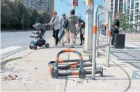  ?? JACK LAKEY ?? New barriers were erected on a traffic island at Lake Shore Blvd. W. and Bathurst St., but they have already been knocked over.