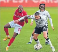  ??  ?? Swansea’s Conor Hourihane, right, keeps Forest’s Fouad Bachirou at arm’s length