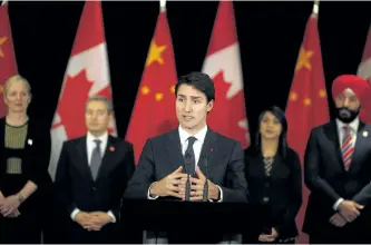  ?? NG HAN GUAN/THE ASSOCIATED PRESS ?? Prime Minister Justin Trudeau, centre, speaks to the media at a hotel in Beijing, China, on Tuesday.