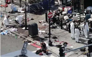  ?? The Associated Press ?? In this April 16, 2013, file photo, investigat­ors examine the scene of the second bombing outside the Forum Restaurant on Boylston Street near the finish line of the 2013 Boston Marathon, a day after two blasts killed three and injured more than 260 people.