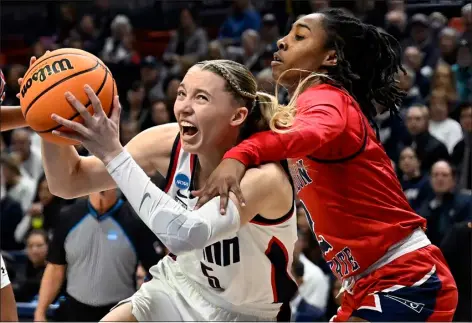  ?? JESSICA HILL — THE ASSOCIATED PRESS ?? Uconn guard Paige Bueckers, left, is fouled by Jackson State guard Miya Crump, right, in the first half of a first-round college basketball game in the NCAA Tournament, Saturday, March 23, 2024, in Storrs, Conn.