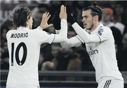  ?? Picture: AFP ?? CLINICAL. Real Madrid’s Gareth Bale (right) celebrates after scoring the opening goal with Luka Modric during their Champions League match against Roma at the Olympic Stadium in Rome on Tuesday night.