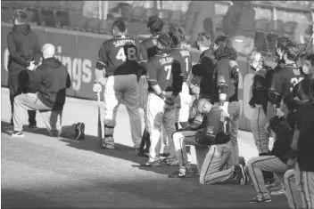  ?? ASSOCIATED PRESS ?? SAN FRANCISCO GIANTS’ ANTOAN RICHARDSON (00) and Jaylin Davis kneel during the national anthem prior to an exhibition baseball game against the Oakland Athletics, Monday, in Oakland, Calif.