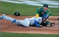 ?? LACHLAN CUNNINGHAM/GETTY IMAGES ?? Athletics catcher Sean Murphy tags Gavin Lux of the Dodgers on Tuesday in Oakland.