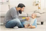  ?? 123RF ?? Parental sharing: Enlightene­d companies help fathers to play their part in bringing up their children from the word go. /