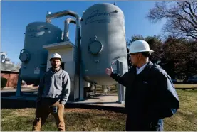  ?? JESSICA GRIFFIN - THE PHILADELPH­IA INQUIRER ?? Aqua Pennsylvan­ia’s Dave Rustay, left, a treatment manager, and president Marc Lucca at the company’s New Britain, Bucks County, plant in 2023.