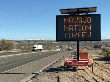 ?? Photograph: Andrew Hay/Reuters ?? A road sign outside Bloomfield in New Mexico. Contact tracers at rural testing sites, like the ones that found throughout the Navajo nation, are often forced to use paper records.