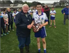  ??  ?? Aughrim’s Sam Carroll is presented with the Plate by Mick Hagan.