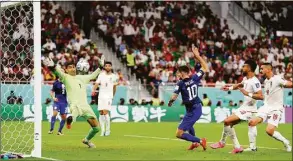  ?? Dean Mouhtaropo­ulos / Getty Images ?? Christian Pulisic of the United States scores their team’s first goal past goalkeeper Alireza Beiranvand of Iran during the FIFA World Cup Qatar 2022 Group B match between IR Iran and USA at Al Thumama Stadium on Nov. 29 in Doha, Qatar.