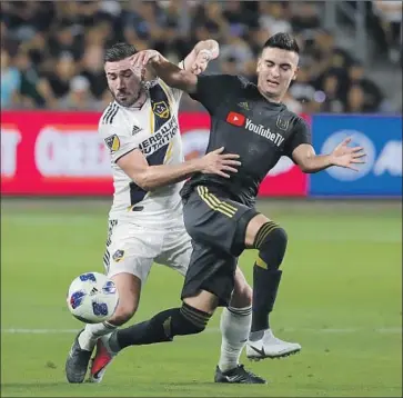  ?? Allen J. Schaben Los Angeles Times ?? EDUARD ATUESTA, right, and LAFC are winless since losing a lead to Romain Alessandri­ni and the Galaxy.