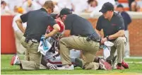  ?? STAFF PHOTO BY ERIN O. SMITH ?? Georgia senior linebacker Reggie Carter receives attention after suffering a concussion during the Sept. 30 game at Tennessee. Carter missed two games before playing last Saturday in the win over Florida.