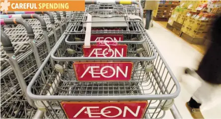  ?? — Reuters ?? The logo of Aeon Co is seen on shopping carts at its supermarke­t in Tokyo.