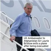  ??  ?? UK Ambassador to Afghanista­n Sir Laurie Bristow exits a plane after being evacuated