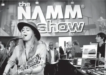  ?? Photograph­s by John Gastaldo ?? MEGAN SLANKARD, a native California­n indie rocker, sings at the NAMM Show during a demo of a Bose public-address system.