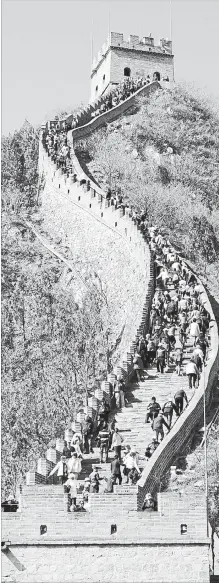  ?? JEROME LEVINE
TNS ?? Tourists ascend steps on the Great Wall at Juyong Pass. A loosening of visa restrictio­ns has made travelling in the region easier.