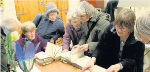  ??  ?? ●●Members of Rochdale Field Naturalist­s studying botanical texts from the 1920s