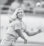  ??  ?? UCLA SOFTBALL outfielder Stevie Wisz throws the ceremonial first pitch at Dodger Stadium.