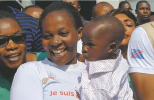  ?? JUSTIN KATUMWA/AP ?? Esperance Nabintu and her 1-year-old son, Ebenezer Fataki, on Tuesday after the two had been declared cured of Ebola, in Goma, Congo. The two were treated with new anti-Ebola drugs by top doctors who said that the disease can be cured if people seek proper care.