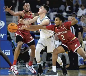  ?? Ashley Landis Associatd Press ?? UCLA GUARD Lazar Stefanovic has the ball knocked away by Maryland guard Jahari Long (2) in the first half. Stefanovic missed all six of his shots and scored one point in 35 minutes. The Bruins shot 31.5% overall.