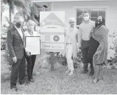  ?? HABITAT FOR HUMANITY OF SOUTH PALM BEACH COUNTY ?? Ushering in the holiday season, Habitat Home Sponsor Sklar Furnishing­s representa­tives shared in the dedication celebratio­n of the Ceasar family home. From left Rick Howard, Pat Howard, Linda Paton, Blake Frankovich and Greta Ceasar gathered in the front yard of the new home.