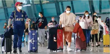  ?? Reuters ?? ↑
Visitors walk after they arrived at the Soekarno-hatta Airport in Tangerang, Jakarta, Indonesia.