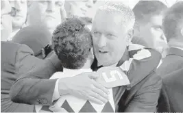  ?? GARRY JONES/AP ?? Trainer Todd Pletcher hugs jockey John Velazquez, who rode Always Dreaming to victory Saturday. Panthers owner Vinnie Viola is among the horse’s owners.