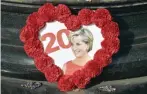  ??  ?? PARIS: This picture shows a photograph of Princess Diana circled by flowers in Paris, around the Flame of Liberty statue plastered with iconic photos, flowers and messages, two days prior to the 20th anniversar­y of her death.