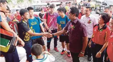  ??  ?? KHAIRY bersalam dengan peserta pada majlis perasmian Kejohanan Badminton Piala Emas Yuen Loong ke 48 di Dewan Ma Hwa Rasah, kelmarin.