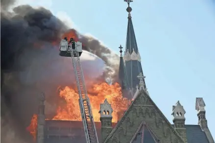  ?? MICHAEL SEARS / MILWAUKEE JOURNAL SENTINEL ?? Firefighte­rs battle a fire at Trinity Lutheran Church at 1046 North 9th Street in Milwaukee. The church was badly damaged by Tuesday afternoon’s blaze. See more photos and video at jsonline.com/news.