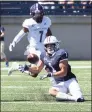  ?? Steve Musco / Submitted photo ?? Yale’s Mason Tipton goes down low to catch a pass in front of Holy Cross defender John Smith during Saturday’s game.