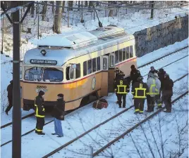  ?? STAFF FILE PHOTOS BY NICOLAUS CZARNECKI ?? ‘OUT OF SERVICE’: First responders evacuate passengers Friday at the scene of a trolley collision near the Cedar Grove Station in Boston.