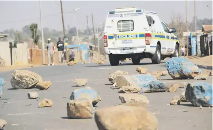  ?? Picture: Cebile Ntuli ?? RESIDENTS’ BLUES. A police van patrols in Finetown after residents took to the streets yesterday after some members of the community decided to occupy land by force at Vlakfontei­n extension 4. Some members claim they have been waiting for 13 years for...